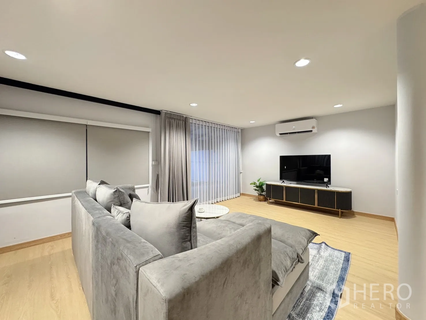 บ้าน ให้เช่า - ห้องนั่งเล่นแบบโอเพ่นพร้อมทีวีและม่านโปร่ง.