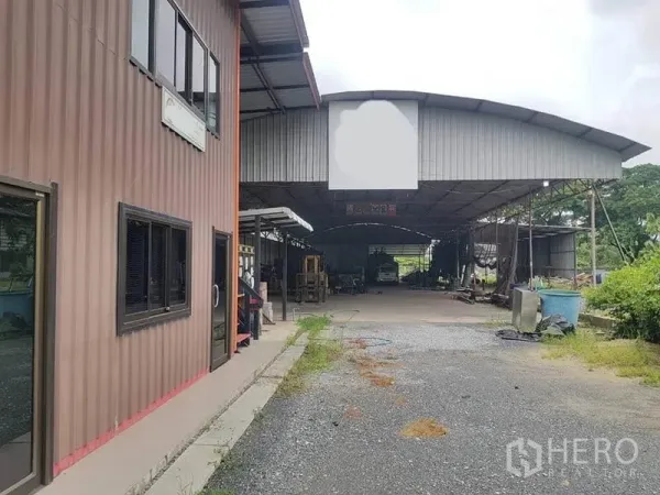 คลังสินค้า ให้เช่าในSai Noi, Nonthaburi - มุมมองด้านหน้าโกดังและอาคารสำนักงาน ลานจอดรถโรยหินกว้าง