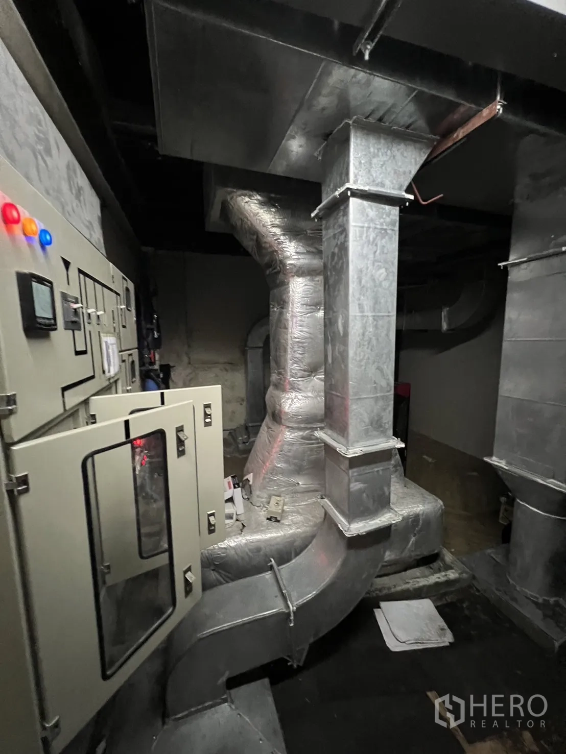 Shophouse for rent in Watthana, Bangkok - Mechanical room housing ventilation ducts and a control panel.