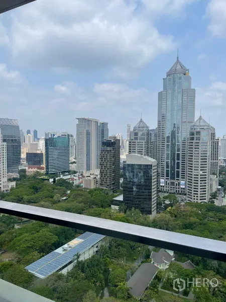 Condominium for rent in Pathum Wan, Bangkok - High-rise balcony view over Bangkok skyline and green parkland.