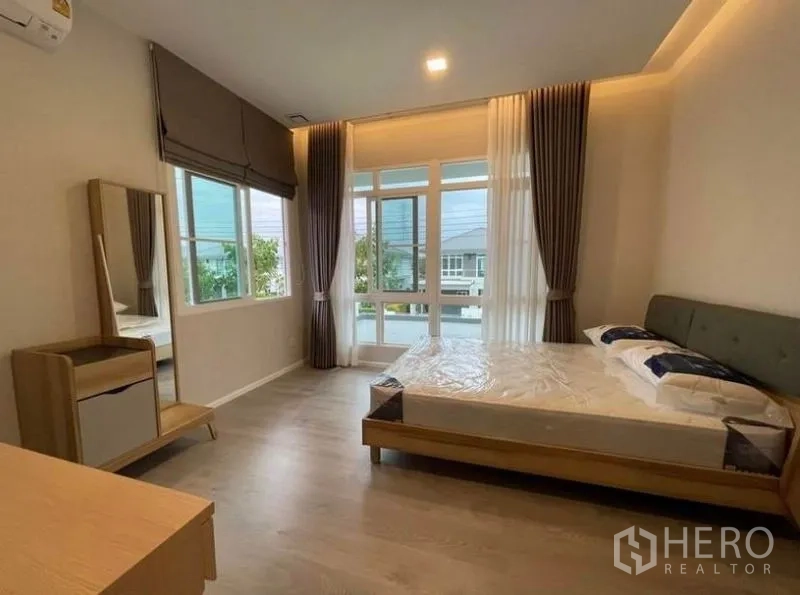 独立式住宅 出租在Prawet, Bangkok - 采光充足的次卧，转角大窗与现代家具。