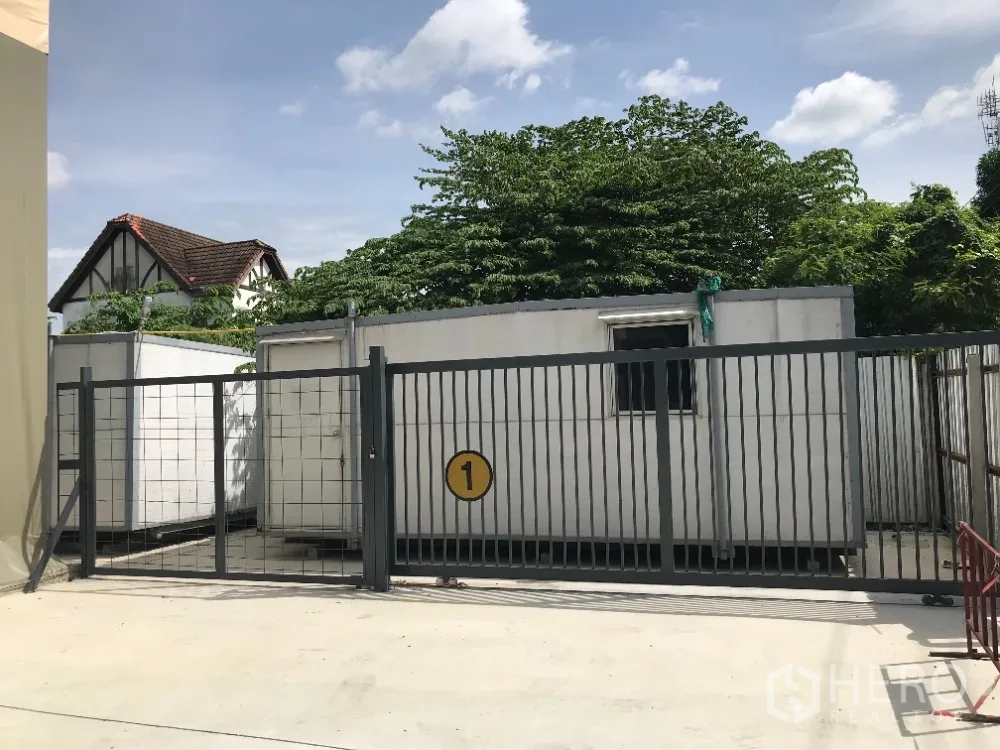 仓库 for rent in Huai Khwang, Bangkok - 仓库入口处设置金属大门，院内有功能舱/活动房。