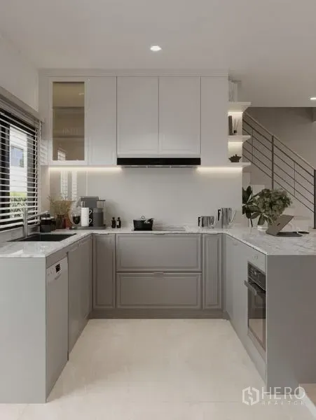 Detached House for rent in Bang Phli, Samut Prakan - U-shaped kitchen with white upper cabinets, marble countertops and soft under-cabinet lighting.