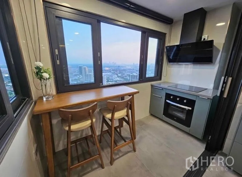 Condominium for rent or sale - Separate kitchen with oven, cooktop and window-side breakfast bar.