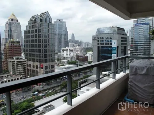 Condominium for rent in Sathon, Bangkok - Balcony with railing overlooking the Sathorn business district skyline.