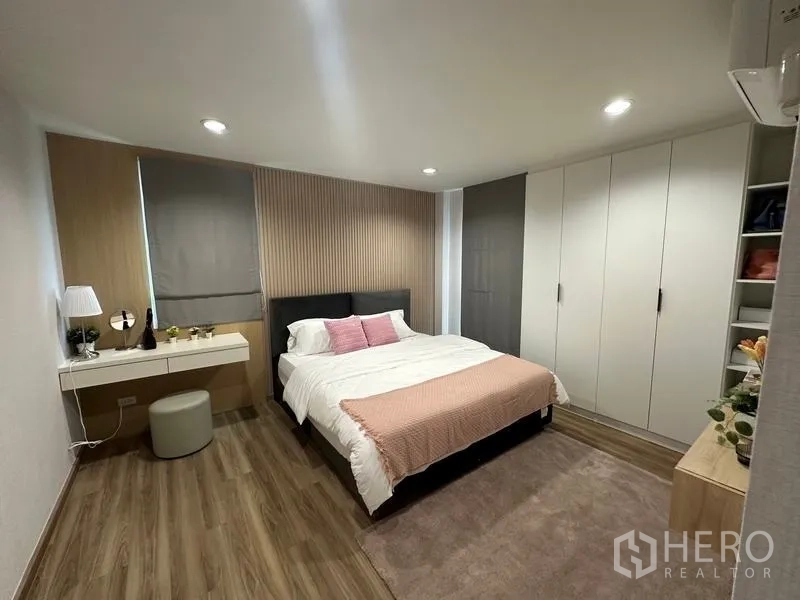 Warehouse for sale in Pathum Thani - Guest bedroom with built-in wardrobes, bedside tables and soft lighting.
