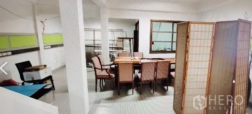 Home Office for rent in Khlong Toei, Bangkok - Dining area with table and chairs, white columns, window and movable partition.