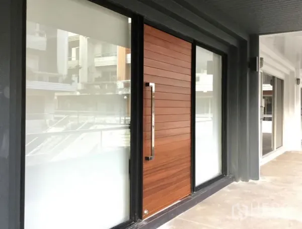 Home Office for rent or sale - Contemporary frontage with frosted glass panels and a wood front door under a covered walkway.