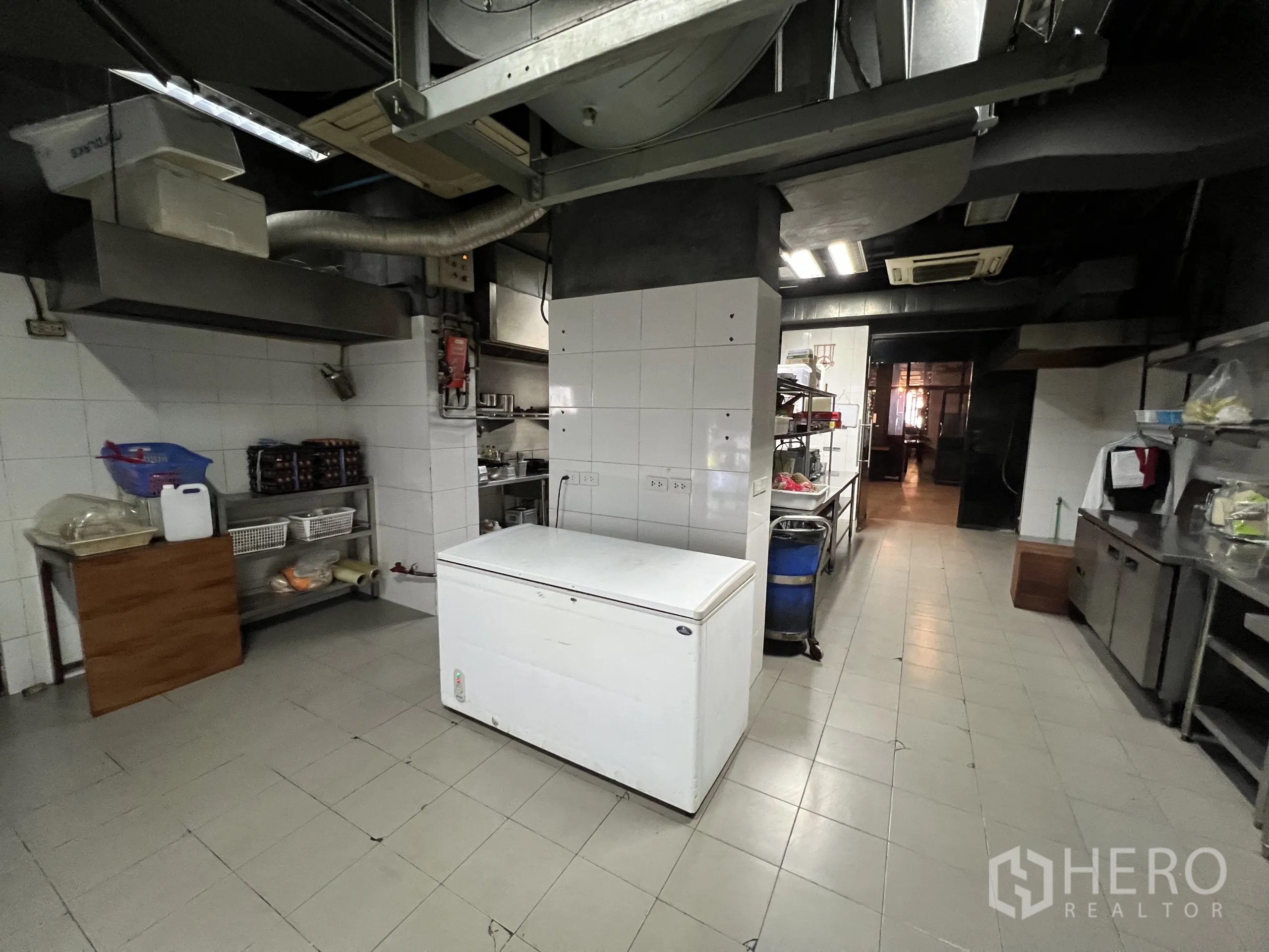 Retail Space for rent in Watthana, Bangkok - Back-of-house kitchen space with freezers, tiled walls, and exposed ductwork.