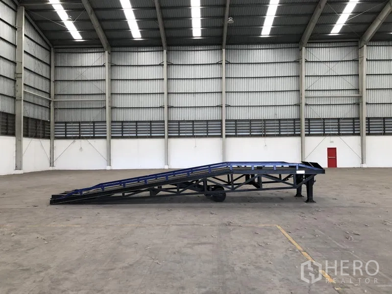 Factory for rent in Wang Noi, Phra Nakhon Si Ayutthaya - Warehouse interior showing a mobile loading ramp positioned on the expansive production floor.