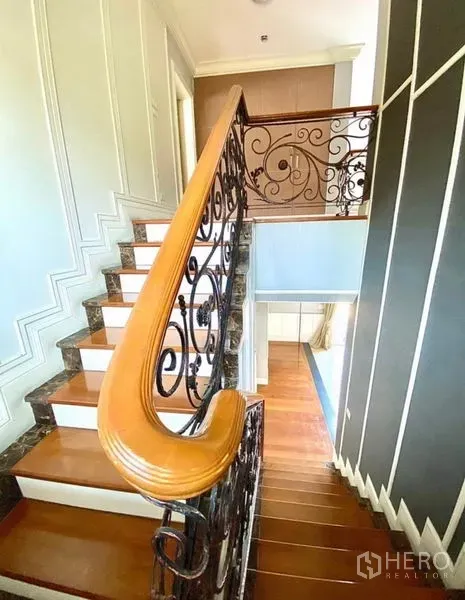 Home Office for rent in Pak Kret, Nonthaburi - Staircase with polished wooden handrail, marble treads and ornate ironwork.