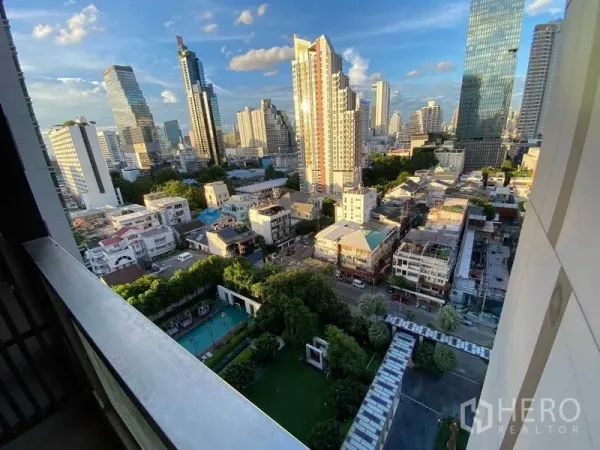 Condominium for rent in Bang Rak, Bangkok - Balcony view over the Silom–Sathorn skyline with pool and garden below.