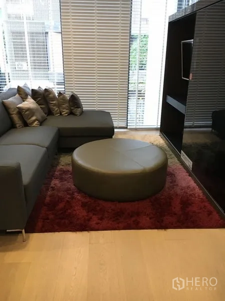 Detached House for rent in Wang Thonglang, Bangkok - Another angle of the living area with sectional sofa facing a built-in TV unit.