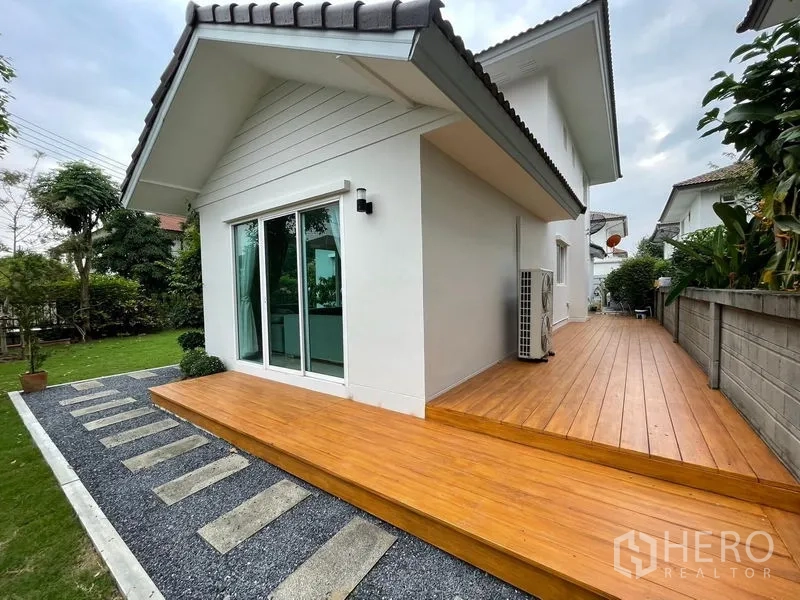 Detached House for sale in Lam Luk Ka, Pathum Thani - Wood deck wrapping the side of the house beside a sliding glass door.