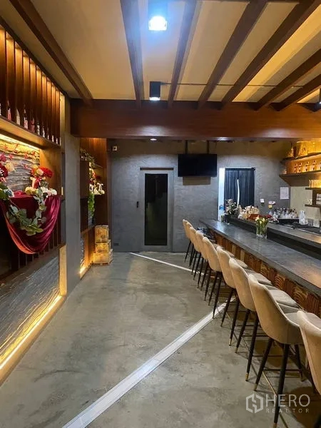 Shophouse for rent - Another view of the bar lounge showing counter seating and illuminated shelving.