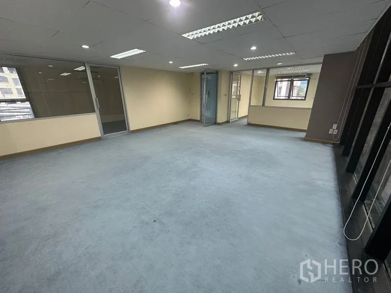 Office Space for rent in Bang Rak, Bangkok - Open workspace with glass partitions and large windows bringing in natural light.
