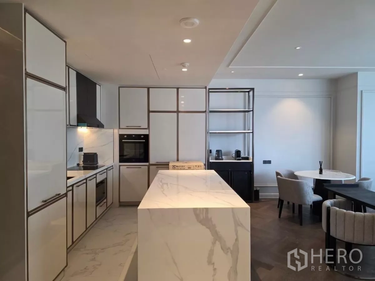 Condominium for rent - Modern kitchen with marble island, integrated appliances, and ample storage cabinetry.