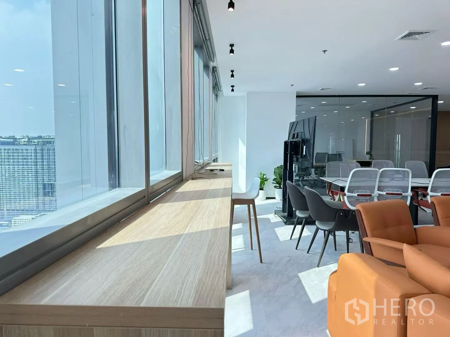 Office Space for rent in Huai Khwang, Bangkok - Bright window ledge and sunlit lounge leading to a glass-partitioned meeting zone.