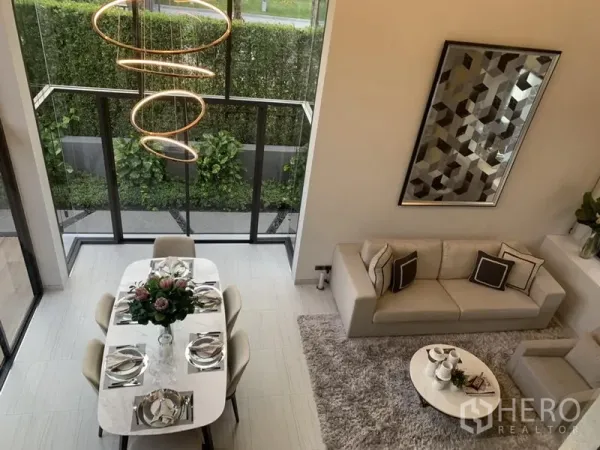 Detached House for sale in Yan Nawa, Bangkok - Double-height living and dining space with floor-to-ceiling windows opening to a private garden.