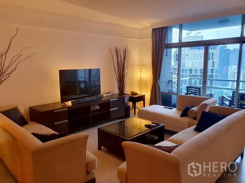 Condominium for sale in Pathum Wan, Bangkok - Living area opening to a glass balcony with skyline view