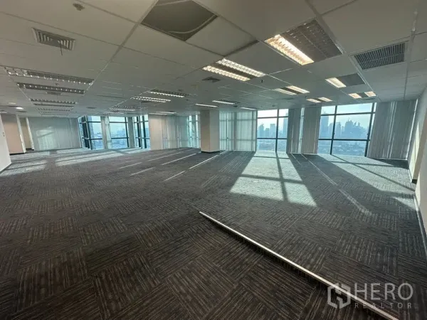 Office Space for rent in Watthana, Bangkok - Expansive open office with suspended ceiling lights and tall glazing facing the skyline.