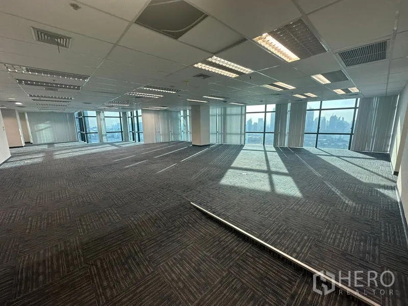 Office Space for rent in Watthana, Bangkok - Expansive open office with suspended ceiling lights and tall glazing facing the skyline.