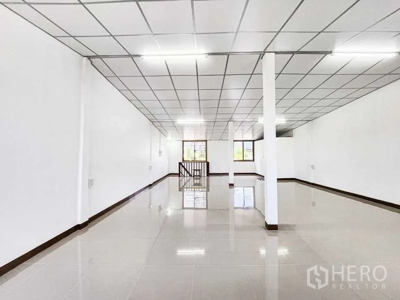 Home Office for rent in Khlong Toei, Bangkok - Upper-level open room with stair opening, grid ceiling and wide windows.