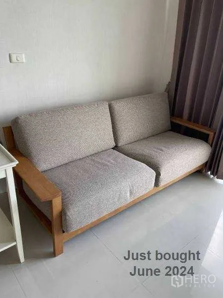 Condominium for sale - New two-seater fabric sofa purchased in June 2024 placed in the living room.