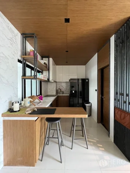 Townhouse for rent in Saphan Sung, Bangkok - Breakfast bar and compact kitchen with wood cabinetry, pendant lights, and large refrigerator.