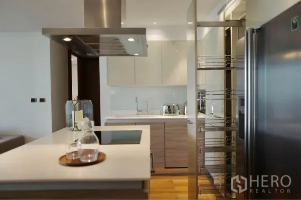 Condominium for rent or sale in Phaya Thai, Bangkok - Contemporary kitchen featuring an induction cooktop island, pull-out pantry and double-door refrigerator.
