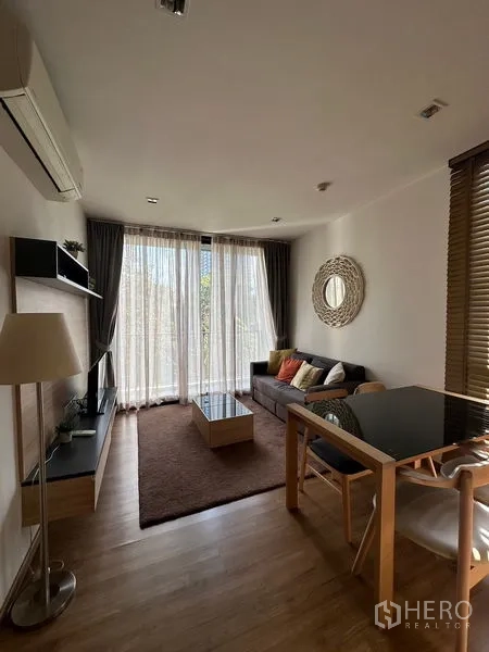 Condominium for rent in Watthana, Bangkok - Kitchen cabinetry with stainless refrigerator near the entrance.
