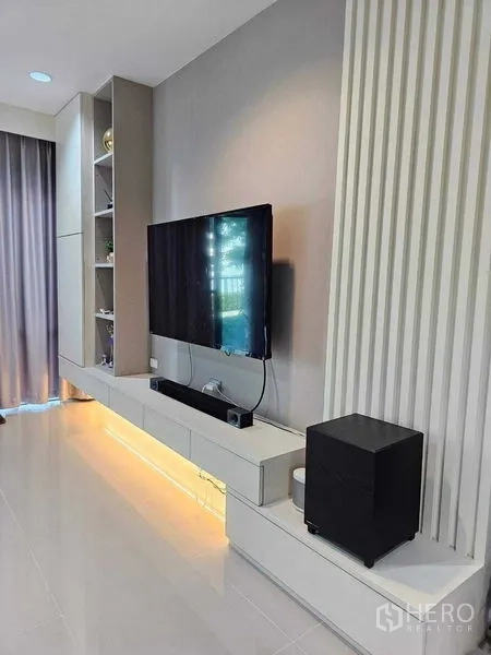 Detached House for sale in Khan Na Yao, Bangkok - Close-up of floating media wall with shelves and warm under-cabinet lighting.