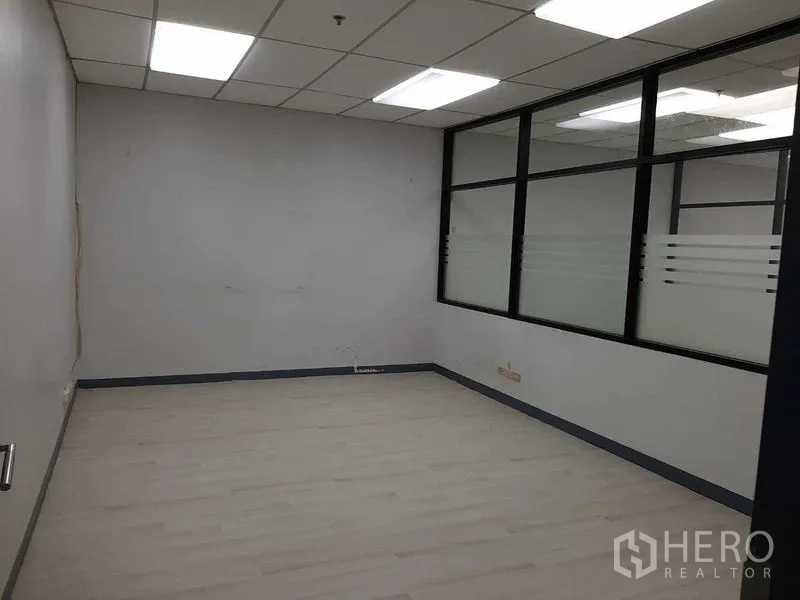 Office Space for rent in Khlong Toei, Bangkok - Enclosed office with interior window and frosted glass strip detail.