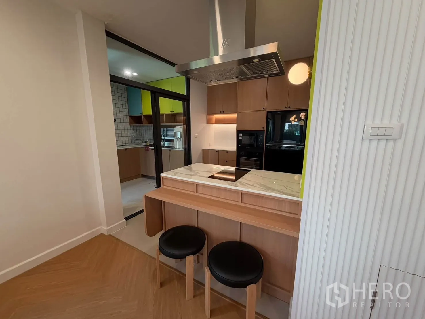 บ้านแฝด for rent in Prawet, Bangkok - เคาน์เตอร์บาร์เตาไฟฟ้าพร้อมมุมมองไปยังครัวเตรียมอาหาร