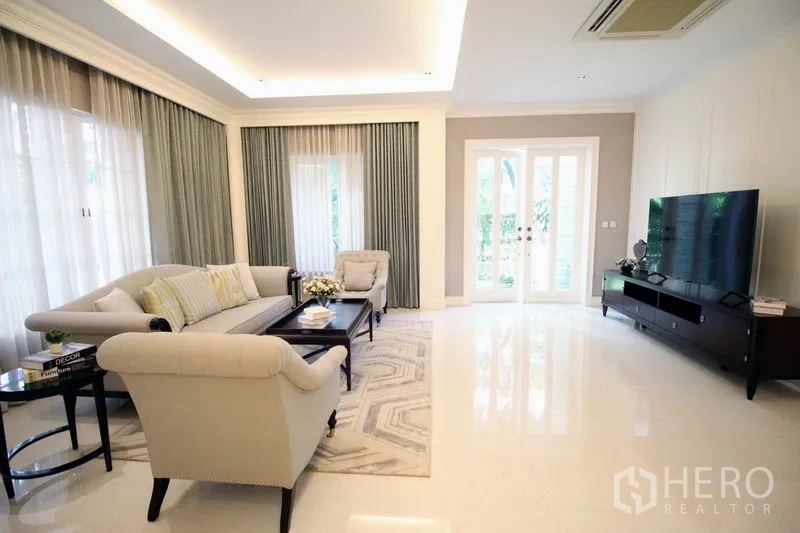 Detached House for rent or sale - Bright lounge with large windows, French doors to the garden and a wall-mounted TV unit.