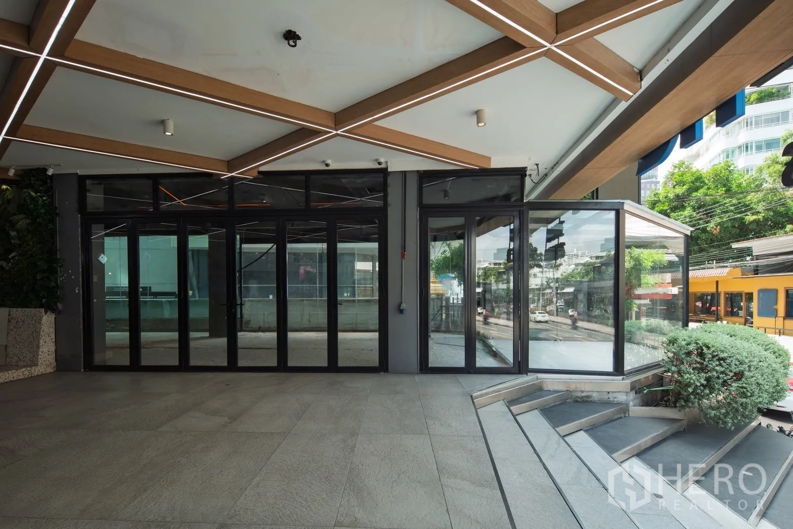 Retail Space for rent in Khlong Toei, Bangkok - Street-facing glass storefront with folding doors, canopy lighting and steps near BTS Thong Lo.