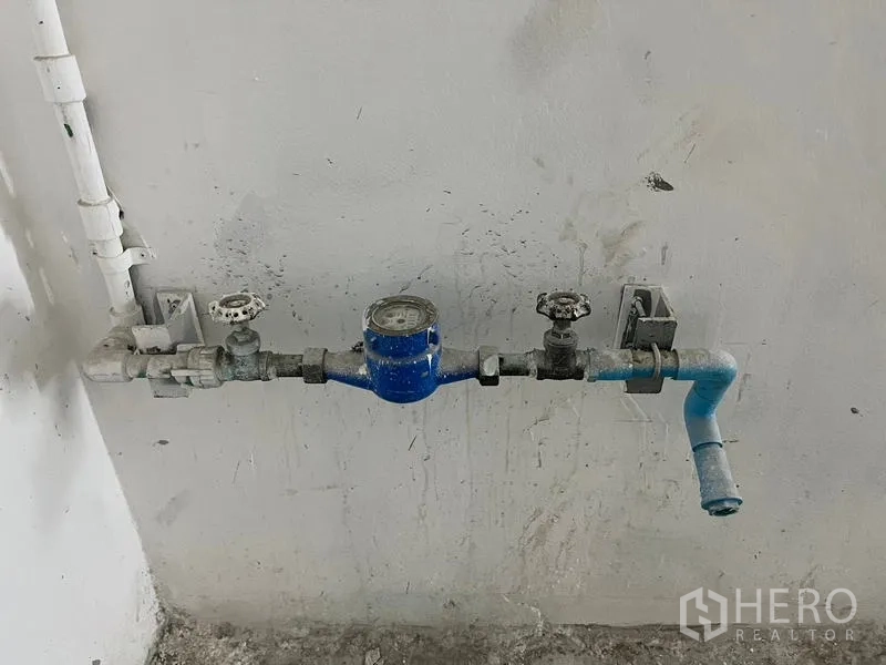 Retail Space for rent - Close-up of the installed water meter and plumbing lines inside the premises.