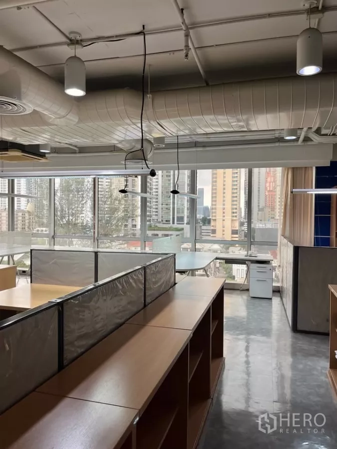 Office Space for rent in Khlong Toei, Bangkok - Cubicle area with wooden storage, printer stand and panoramic windows toward high-rises.
