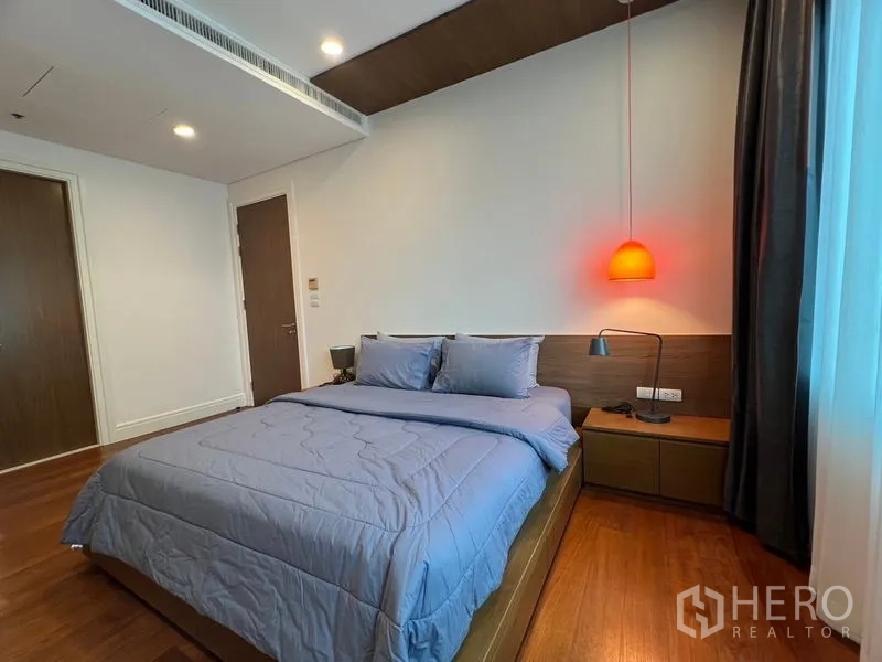 Condominium for rent in Khlong Toei, Bangkok - Bedroom angle highlighting pendant bedside light and nightstands.