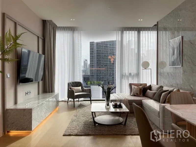 Condominium for rent in Watthana, Bangkok - Bright living room with floor-to-ceiling windows, city skyline view, and a marble TV console.