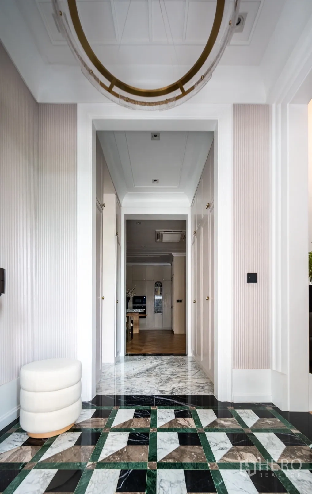Detached House for rent or sale in Phra Khanong, Bangkok - Grand foyer corridor with patterned marble floor leading toward the kitchen.