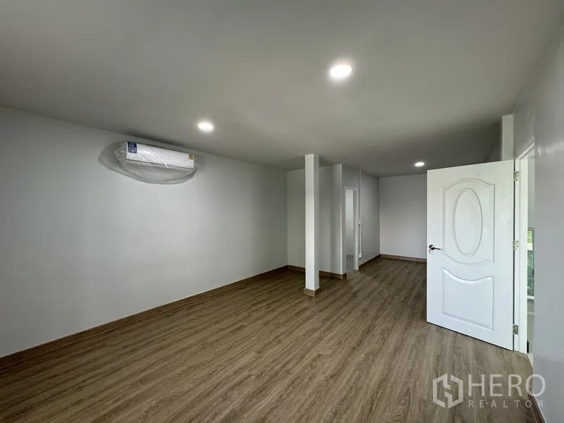 Townhouse for sale in Bueng Kum, Bangkok - Another large bedroom with wood flooring and door to corridor.