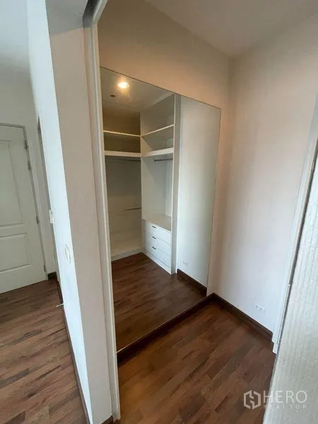 Condominium for sale - Dressing area with full-height mirror and sliding-door wardrobe.