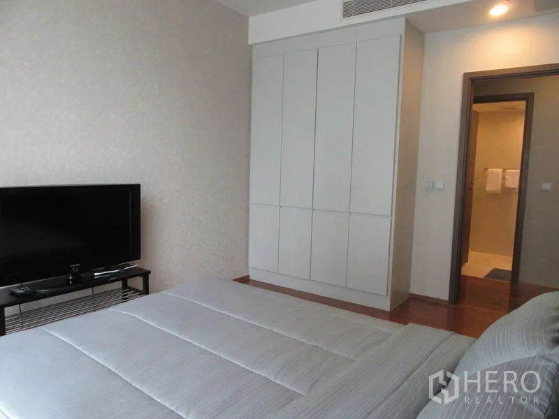 公寓 出租或出售在Watthana, Bangkok - 卧室配电视柜、通顶衣柜及通往套卫的门口。