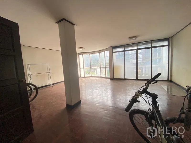 Retail Space for rent in Watthana, Bangkok - Large open-plan room with floor-to-ceiling corner windows and parquet flooring with city outlook.