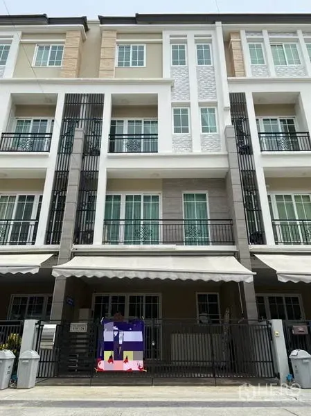 Townhouse for rent in Bang Na, Bangkok - Modern multi‑level townhouse facade with balconies and black metal accents in Bang Na, Bangkok.