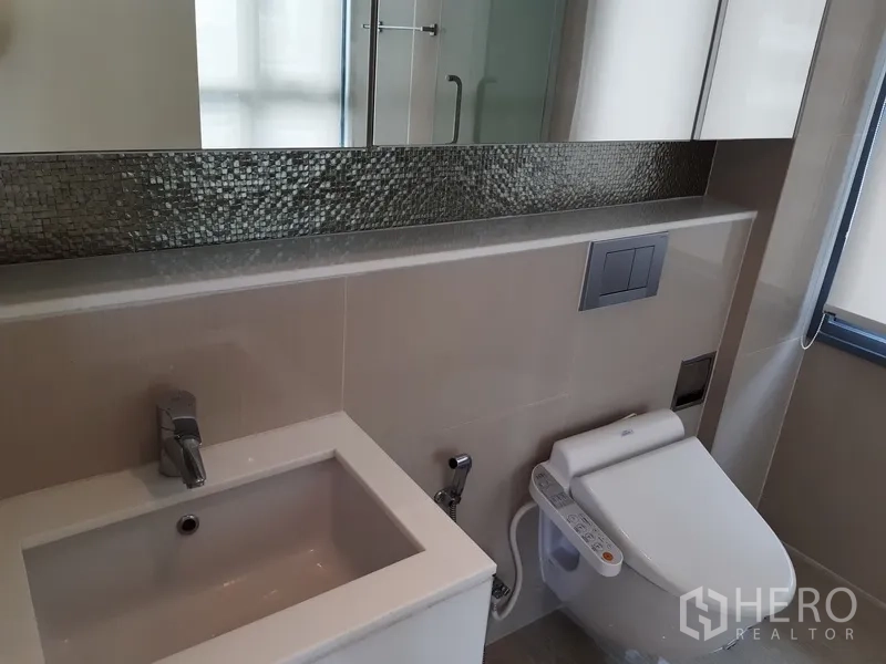 公寓 出租在Watthana, Bangkok - 主卫设长条马赛克镜、洗手台与智能马桶。