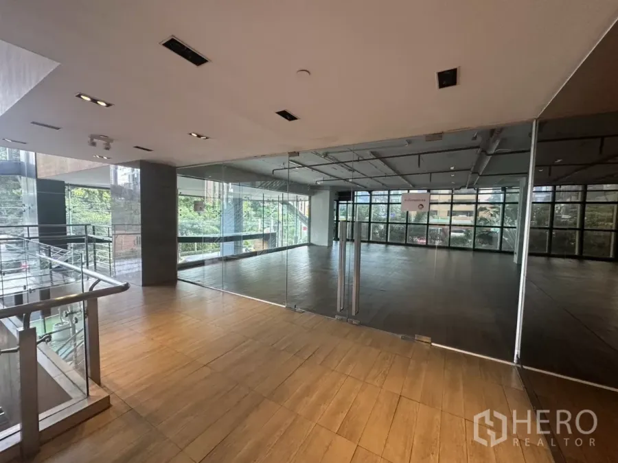 Retail Space for rent - Glass-fronted retail entrance with wood flooring and city views near BTS Ekkamai.