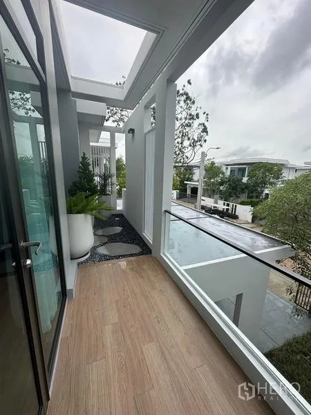 Detached House for rent in Samut Prakan - Covered balcony with wood decking, planters and neighborhood view.
