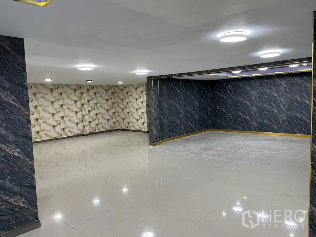 Detached House for rent in Watthana, Bangkok - Large multipurpose tiled room with modern ceiling lights and decorative walls.